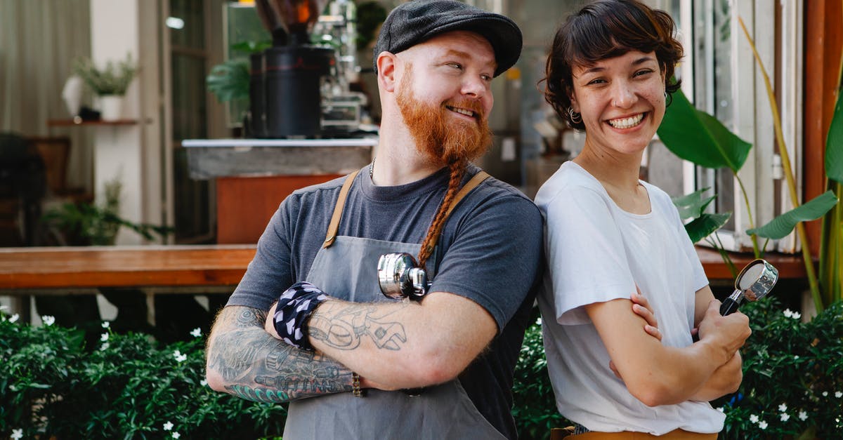 How do I summon an armor stand with arms that will work? - Couple of smiling barista coworkers in casual outfit and aprons standing with portafilter near cafeteria in street near plants in daylight How do I summon an armor stand with arms that will work? - Couple of smiling barista coworkers in casual outfit and aprons standing with portafilter near cafeteria in street near plants in daylight