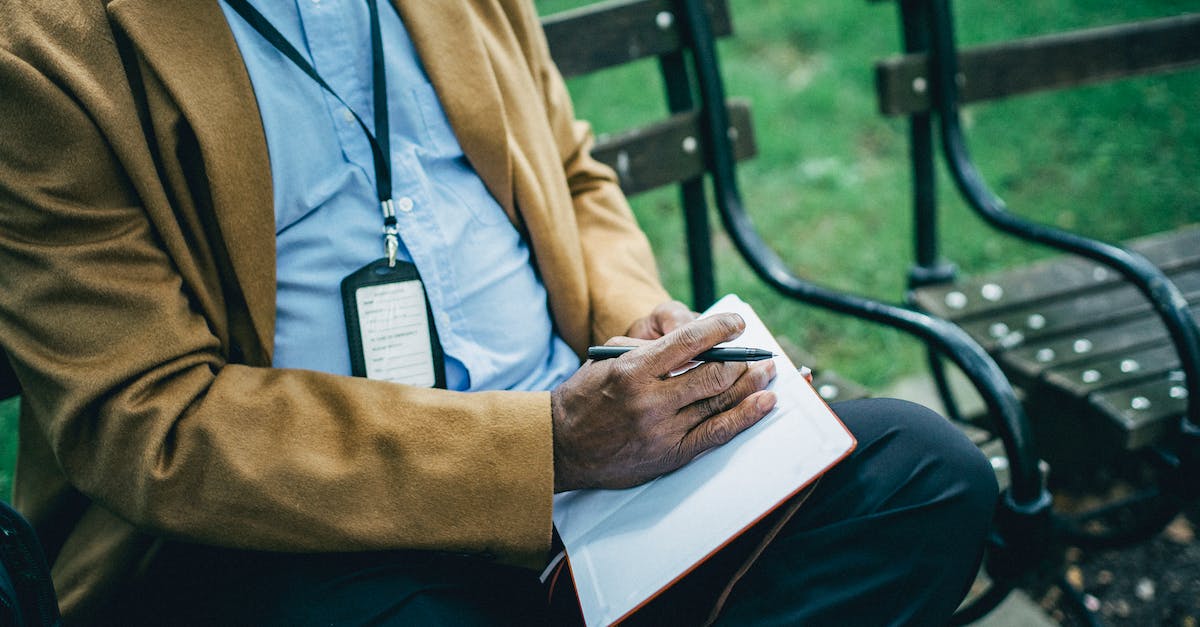 How do I take off a suit in NBA 2K14 my career? - Crop anonymous African American male in formal wear sitting on wooden bench in park and taking notes in notebook How do I take off a suit in NBA 2K14 my career? - Crop anonymous African American male in formal wear sitting on wooden bench in park and taking notes in notebook