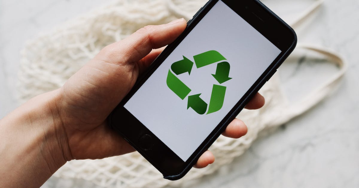 How do I take off body armor in GTA V online? [duplicate] - Crop unrecognizable person showing smartphone with recycle logo on screen