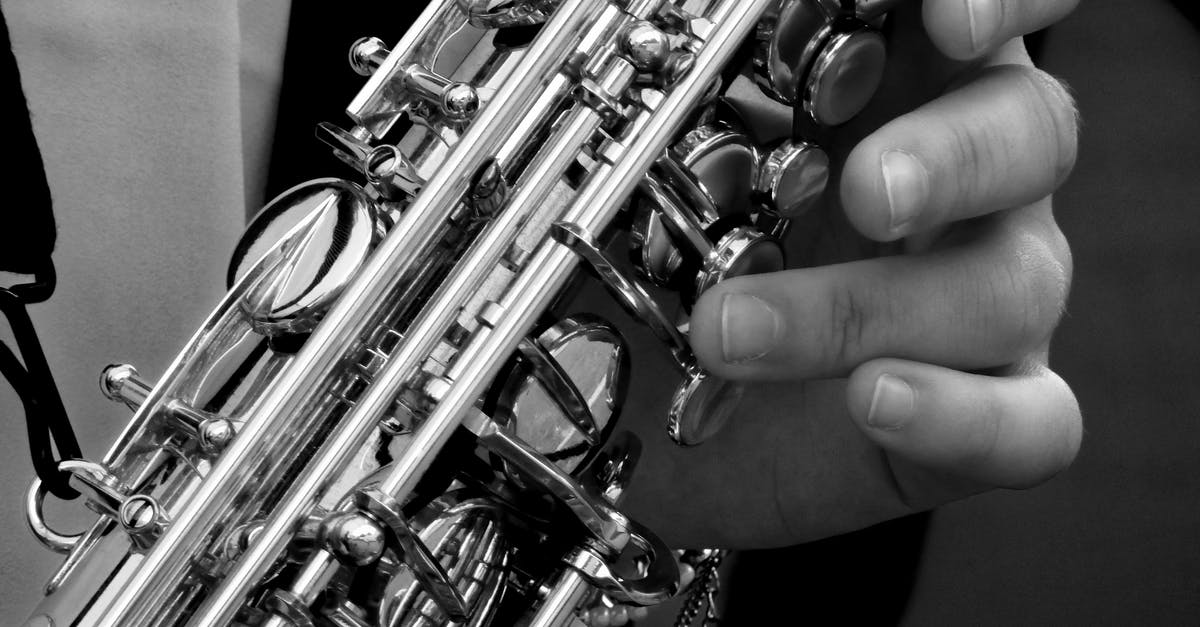 How do I tell if I'm playing on a Valve server? - Person Holding Saxophone in Gray Scale Photography