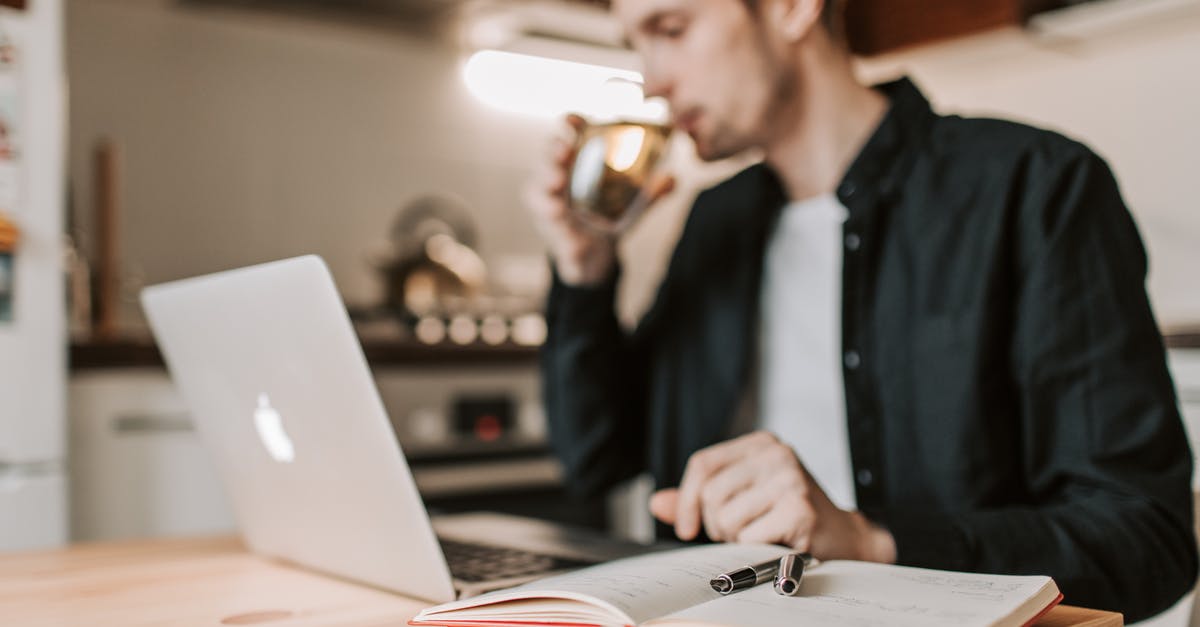 How do i testfor a player using a water bucket with scoreboards? - Crop male freelancer drinking water while watching laptop in kitchen