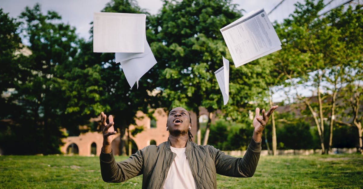 How do I throw a Curveball? - Happy young black male freelancer throwing papers while celebrating successful project during remote work in green park How do I throw a Curveball? - Happy young black male freelancer throwing papers while celebrating successful project during remote work in green park