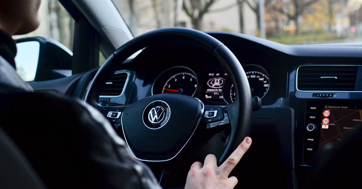 How do I turn off the controller vibration? - Back view of crop anonymous male driving contemporary transport while turning steering wheel in daylight How do I turn off the controller vibration? - Back view of crop anonymous male driving contemporary transport while turning steering wheel in daylight