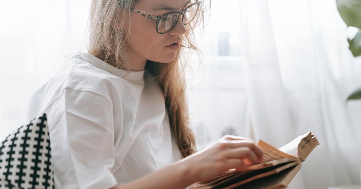 How do I turn off the News? - Focused woman flipping page of book