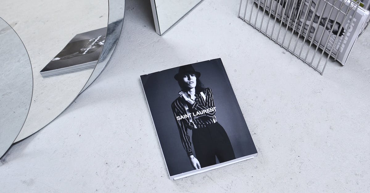 How do I unlock new outfits for my Mii? - Black and white high angle fashion magazine placed on table and reflecting in geometrical mirror and rack with journals