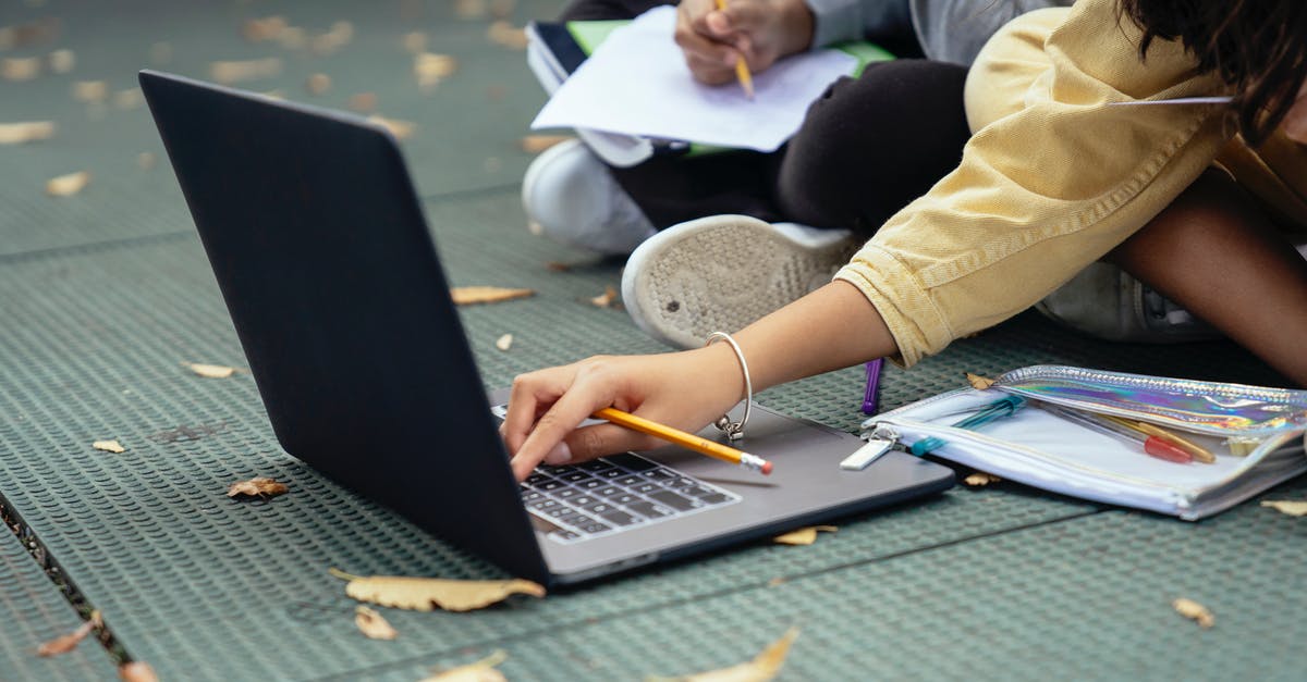 How do I unlock online levels in SMB? - Faceless diverse schoolchildren typing on laptop while studying on street