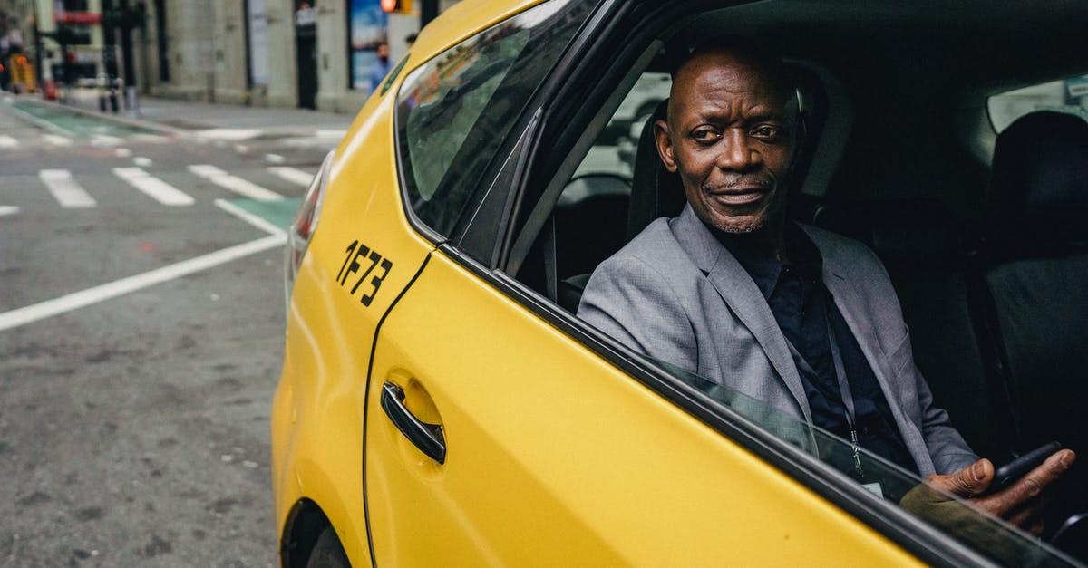 How do I use auto-move? - Happy confident mature African American male looking away and expecting important message on mobile phone while sitting in yellow automobile How do I use auto-move? - Happy confident mature African American male looking away and expecting important message on mobile phone while sitting in yellow automobile