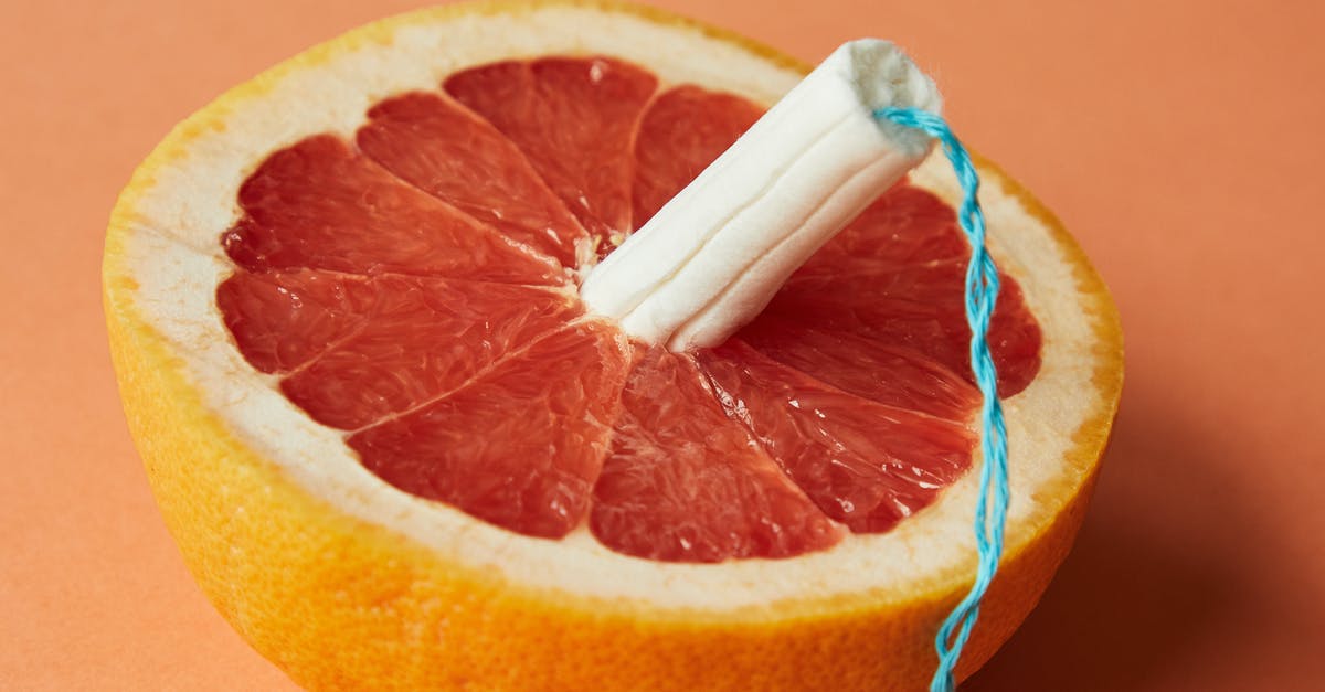 How do I use Triple Notch without triggering High Volley - From above of half of sliced ripe grapefruit with tampon in center showing use of feminine product during menstruation
