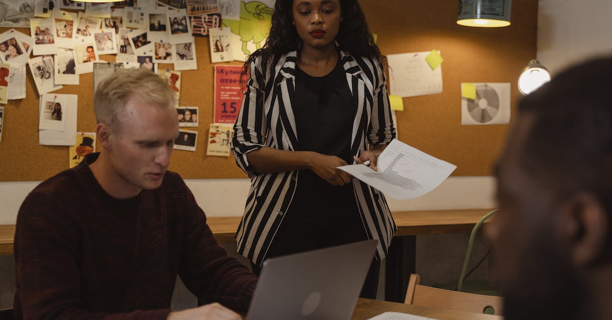 How do I use White soapstone? - Woman in Black and White Coat Standing Beside Man Sitting Using Laptop