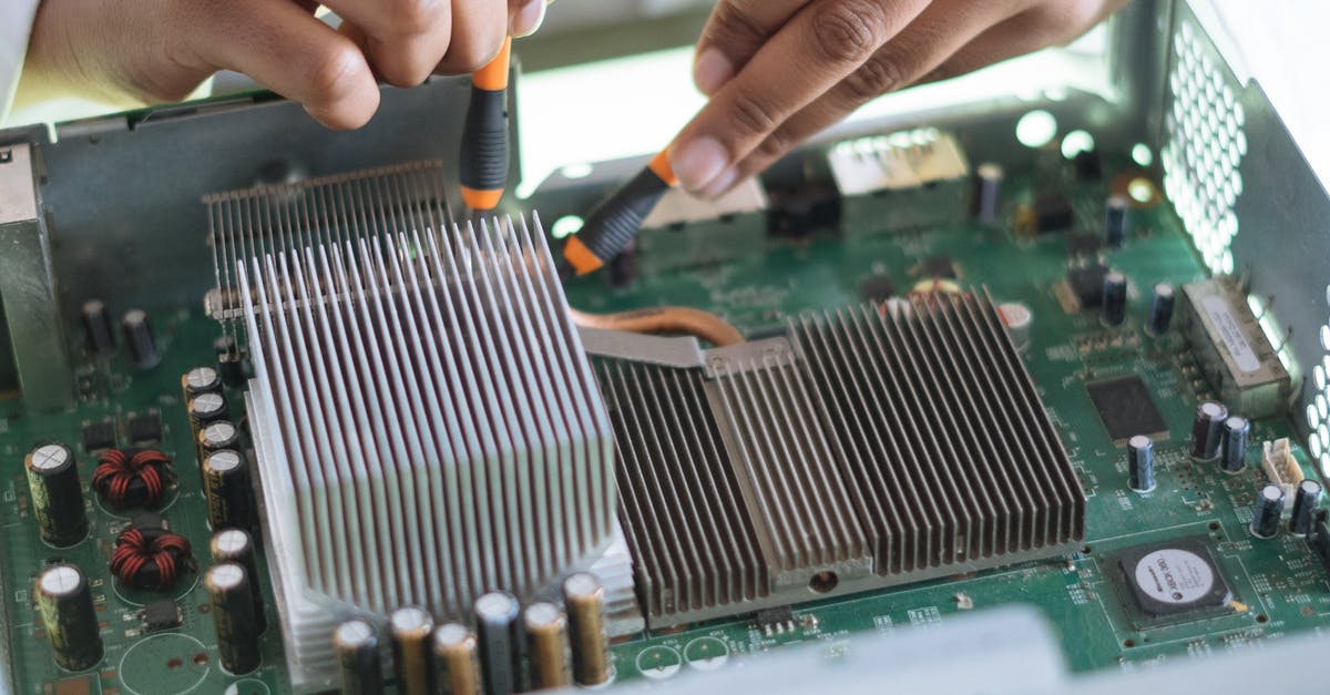 How do I use White soapstone? - Crop technician checking contacts on motherboard in workshop