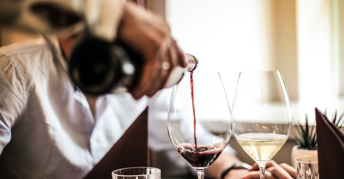 How do items affect videos? - Crop man pouring red wine in glass in restaurant