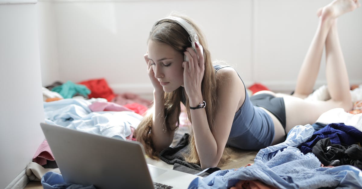 How do items affect videos? - Young woman watching movie in headphones in messy room
