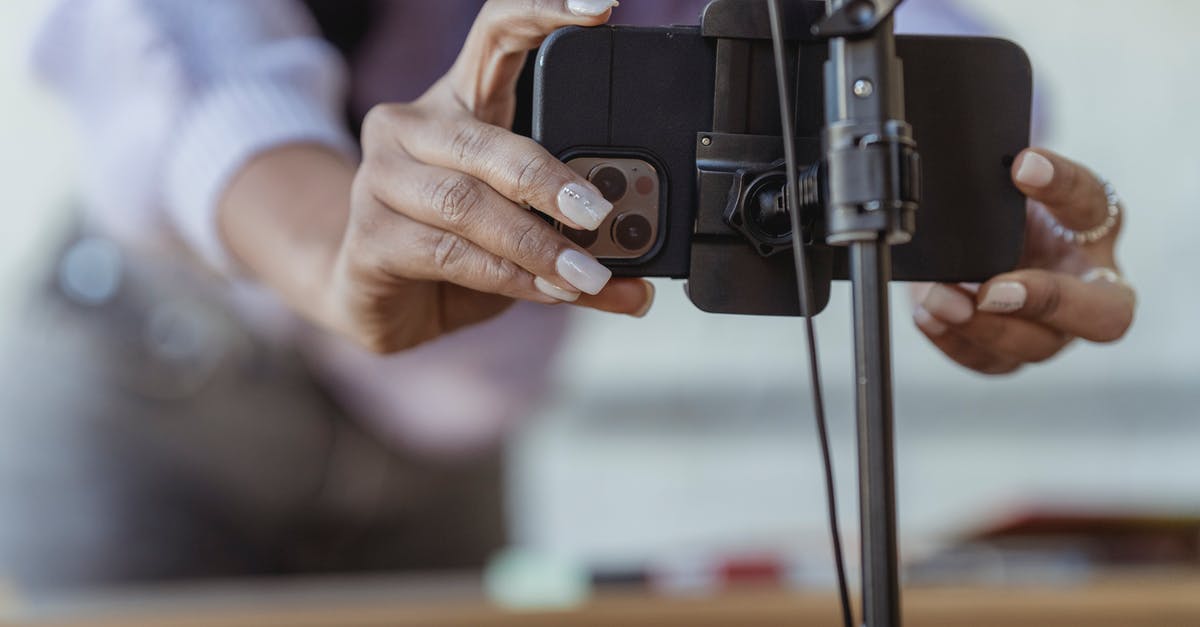 How do multiple Mobile Processing Labs work? - Crop unrecognizable female setting mobile phone on tripod while recording vlog on blurred background How do multiple Mobile Processing Labs work? - Crop unrecognizable female setting mobile phone on tripod while recording vlog on blurred background