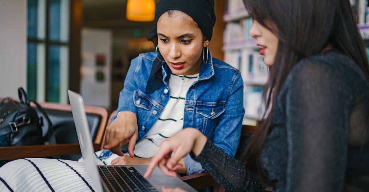 How do people collaborate on maps - Two Women Looking And Pointing At Macbook Laptop