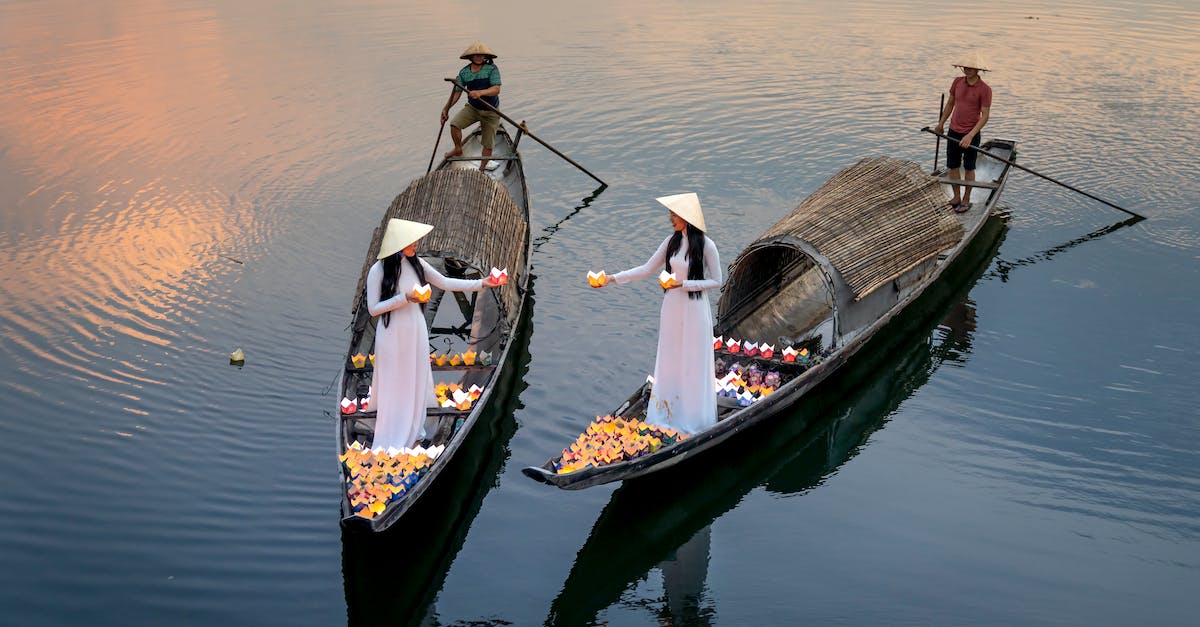How do similar procs interact? - From above of anonymous female speaking in boats with candle lanterns against male partners with paddles in boats on river