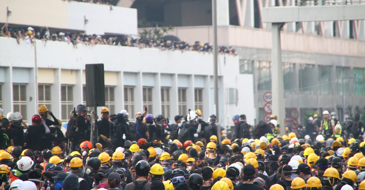 How do the Attack and Defense stats work in Pokémon GO? - Crowd of workers on mass meeting for rights