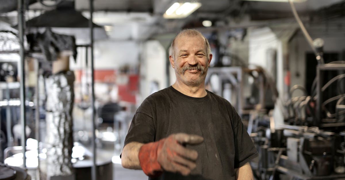 How do the covert ops mechanic work in Beyond Earth? - Cheerful senior white hair craftsman in heavy duty gloves laughing in workshop while looking at camera How do the covert ops mechanic work in Beyond Earth? - Cheerful senior white hair craftsman in heavy duty gloves laughing in workshop while looking at camera