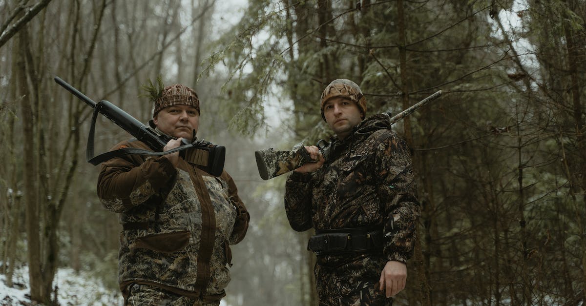 How do the weapons and ammo introduced by update 27 and 31 (Gage Sniper, Shotgun Pack DLCs) work? - Two Men Standing on Forest Holding Rifles