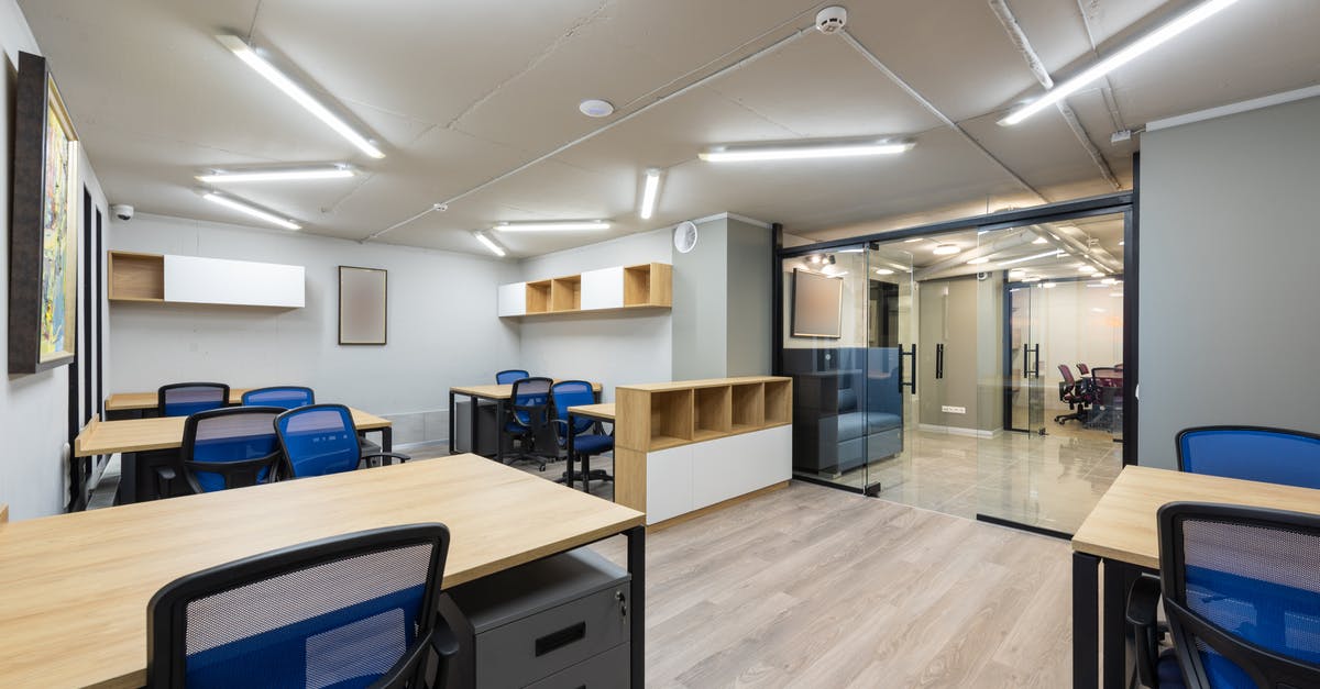 How do these 'door blockers' work, and is there an equivalent in real life? - Contemporary office with glass doors and new furniture