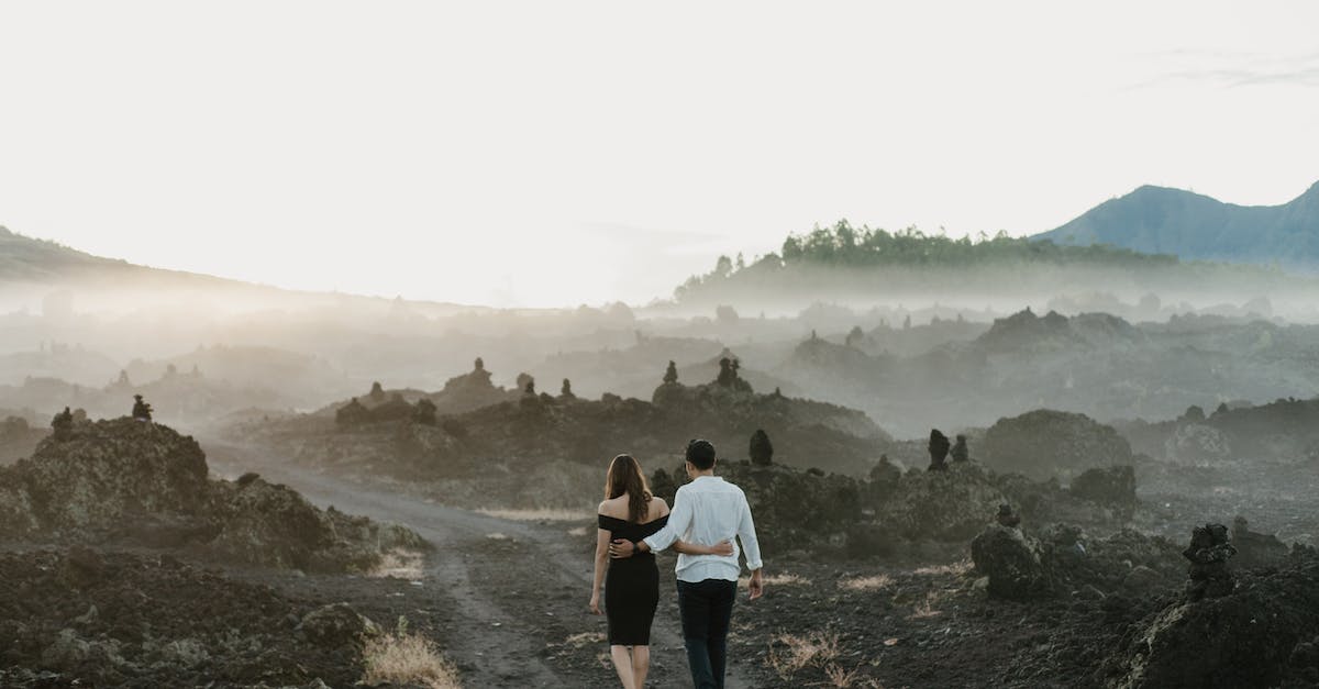 How do these terrain mountains/ledges affect gameplay? - Unrecognizable couple embracing while walking on pathway near mountains