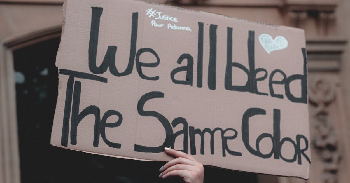 How do units reform formations after disruption? - Hand holding cardboard sign at protest