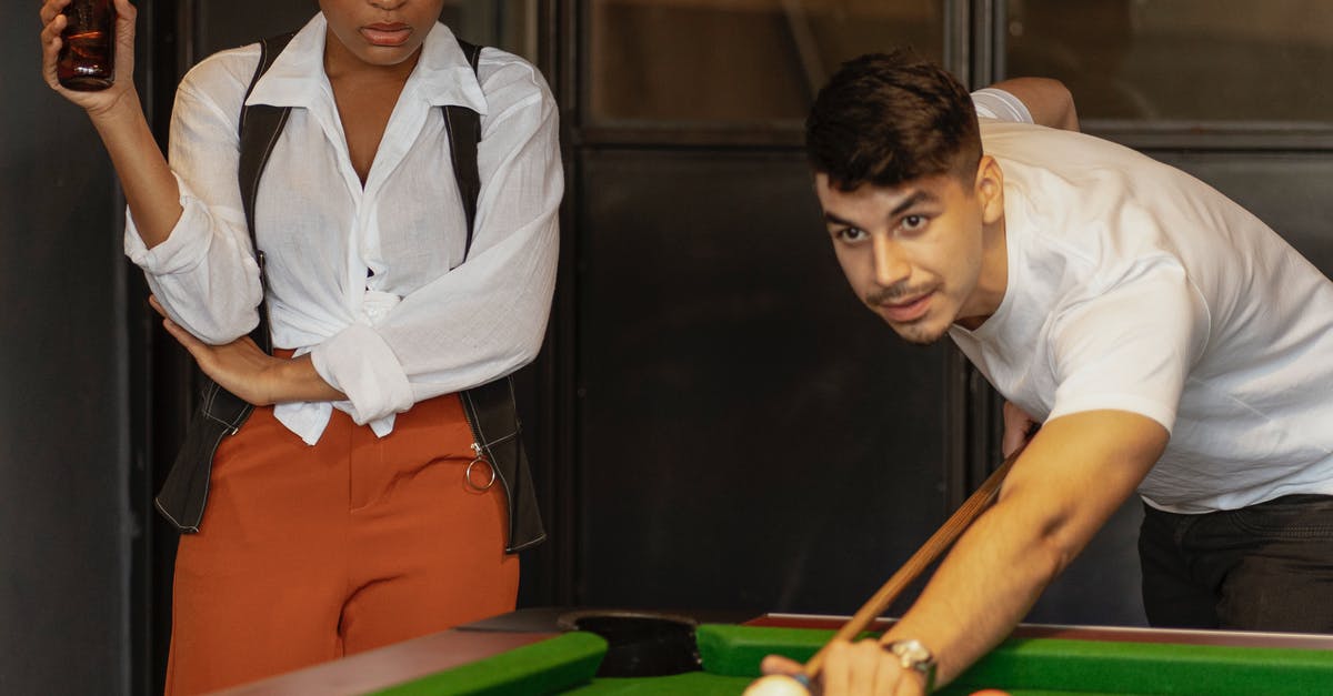 How do units reform formations after disruption? - Woman in White Button Up Shirt and Orange Pants Playing Billiard