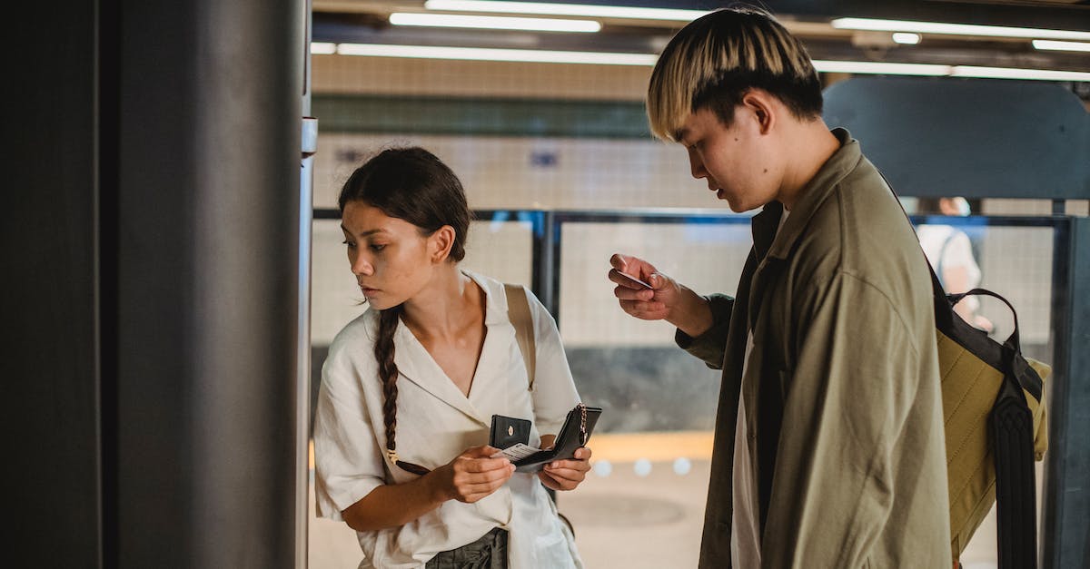How do vending machine Upgrades work? - Concentrated Asian couple in casual clothes with wallet and credit cards in hands standing in underground passage How do vending machine Upgrades work? - Concentrated Asian couple in casual clothes with wallet and credit cards in hands standing in underground passage
