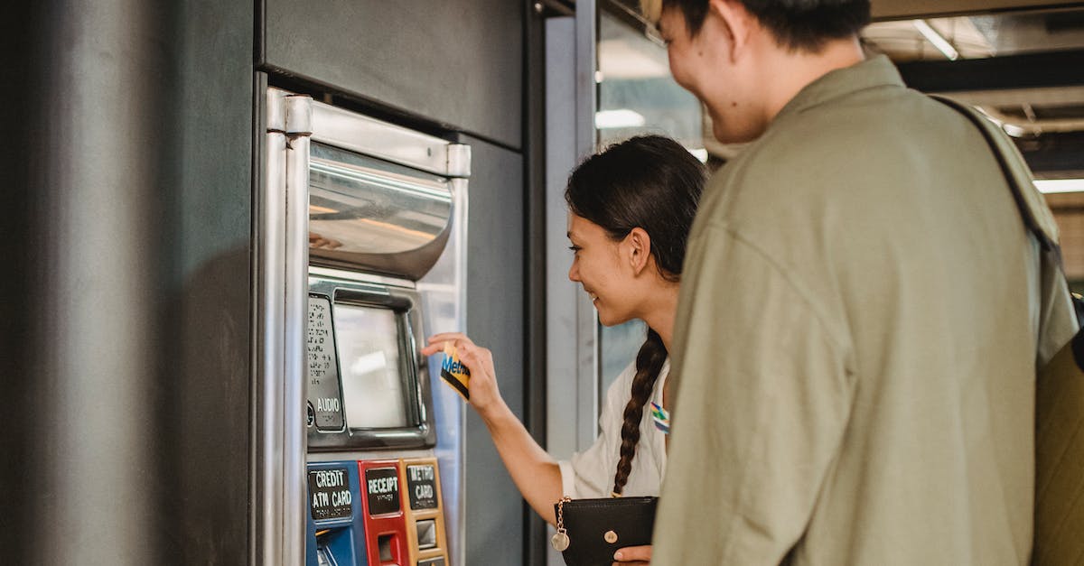 How do vending machine Upgrades work? - Content couple using ticket machine in underground How do vending machine Upgrades work? - Content couple using ticket machine in underground