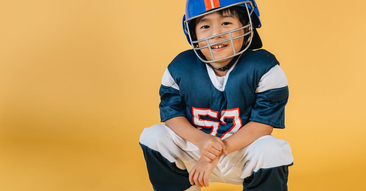 How do you assign a role to a random player in Rec Room? - Positive Asian boy wearing protective helmet and sportswear of American football player in yellow studio