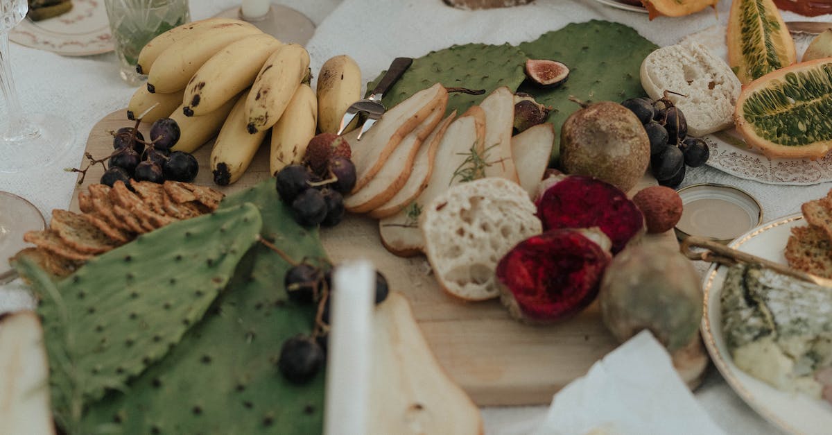 How do you beat Cytosinor in Calculords - From above of fresh fruit with snacks green opuntia and bread on white cloth for picnic