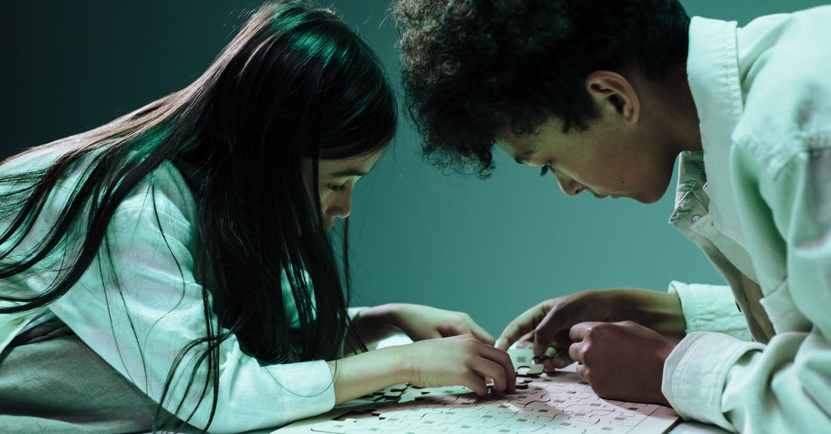 How do you become friends with someone? - Teenage girl and boy doing jigsaw puzzles laying on table How do you become friends with someone? - Teenage girl and boy doing jigsaw puzzles laying on table