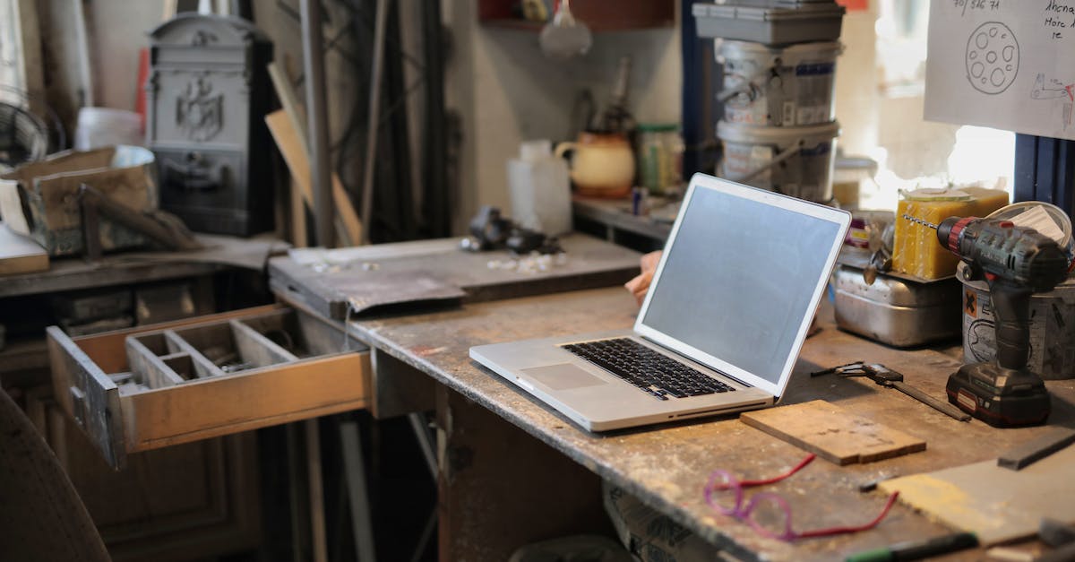 How do you break rotary craft blocks? - From above of modern laptop laying at table among different tools and equipment in workshop
