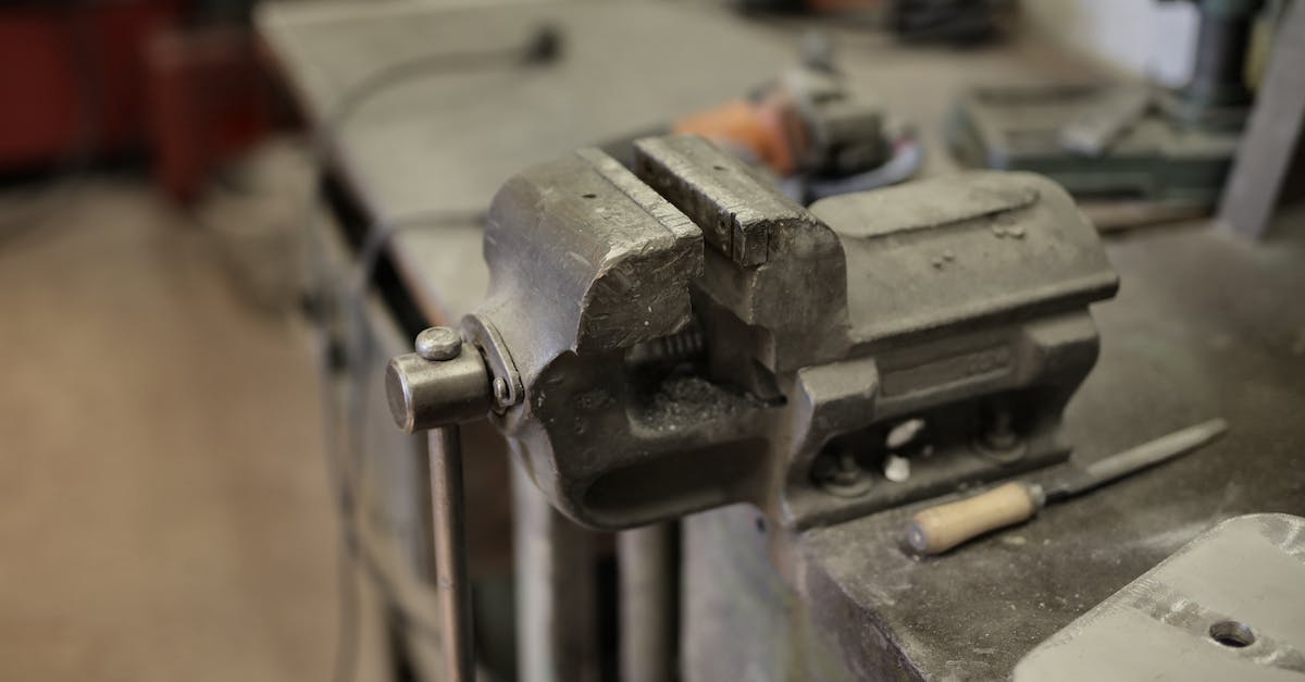 How do you break rotary craft blocks? - From above of vise fixing at workbench among different tools in workshop How do you break rotary craft blocks? - From above of vise fixing at workbench among different tools in workshop