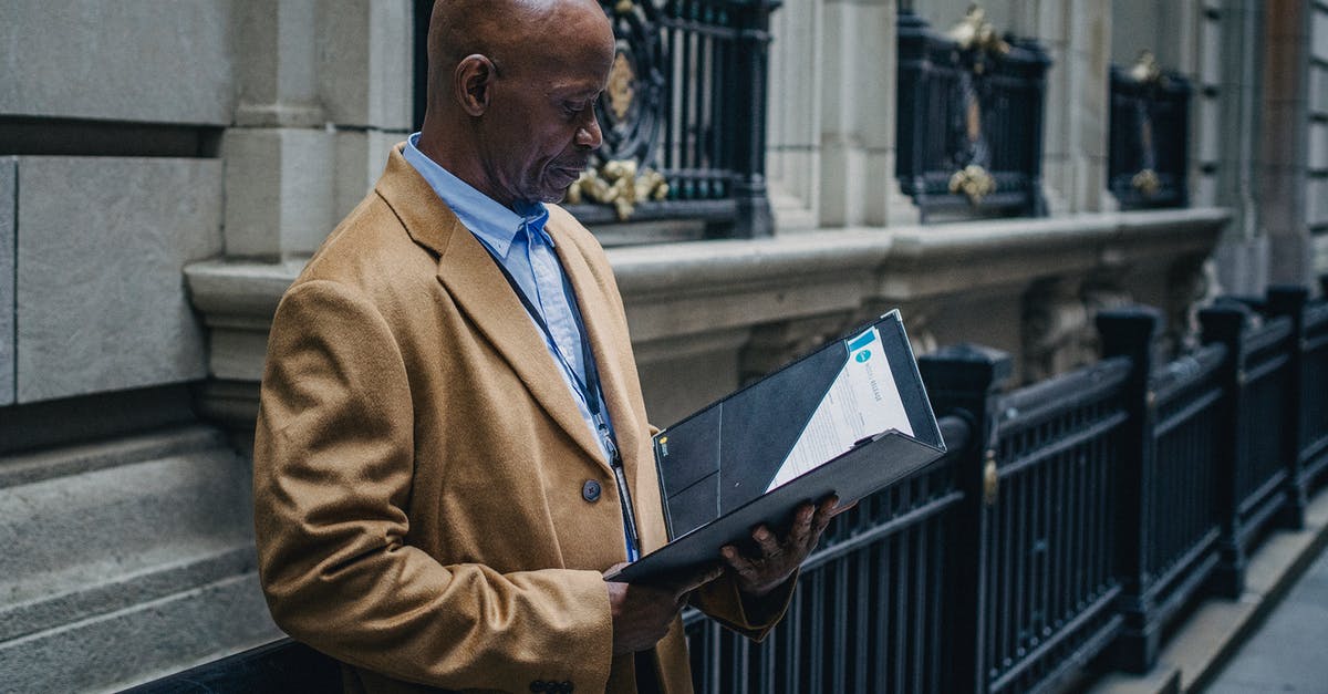How do you check your units current experience in Civ 6? - Experienced black lawyer reading documents on street