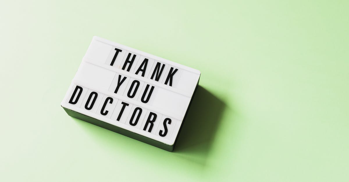 How do you cure a zombie villager? - From above of vintage light box with THANK YOU DOCTORS inscription placed on green surface