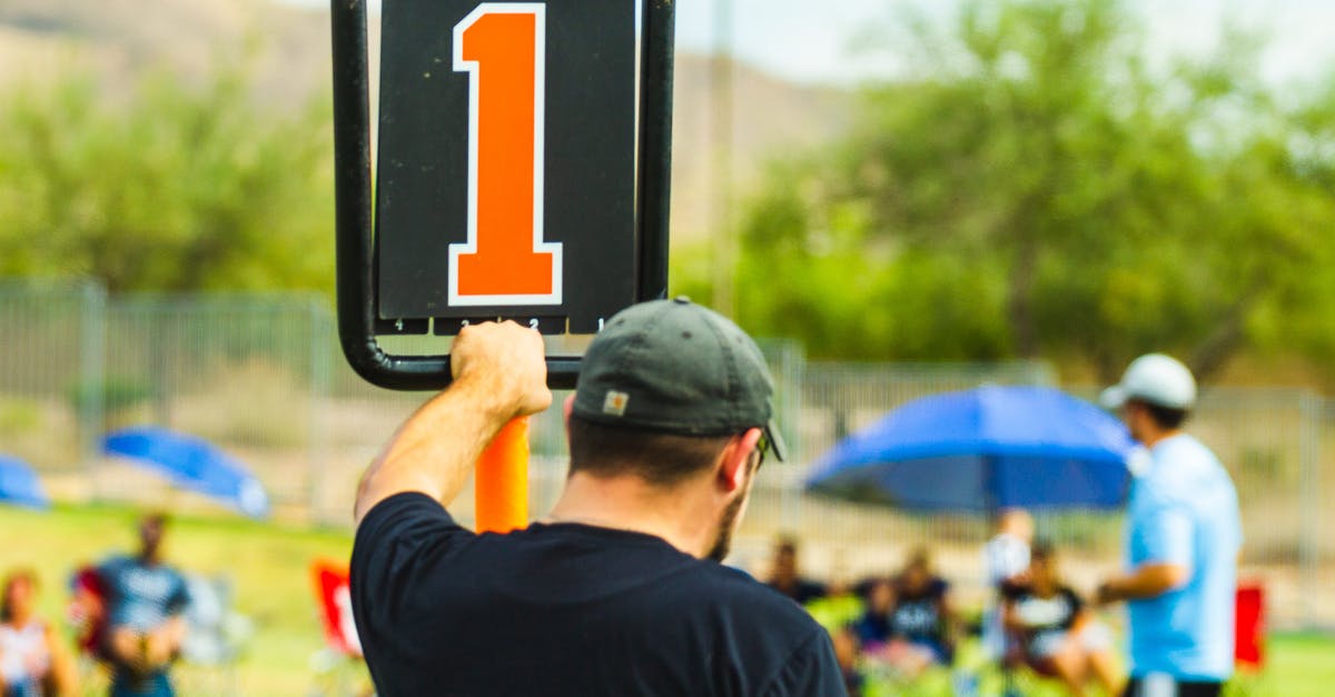 How do you decrease the score on a scoreboard? (Minecraft) - Unrecognizable man near scoreboard during sports competition