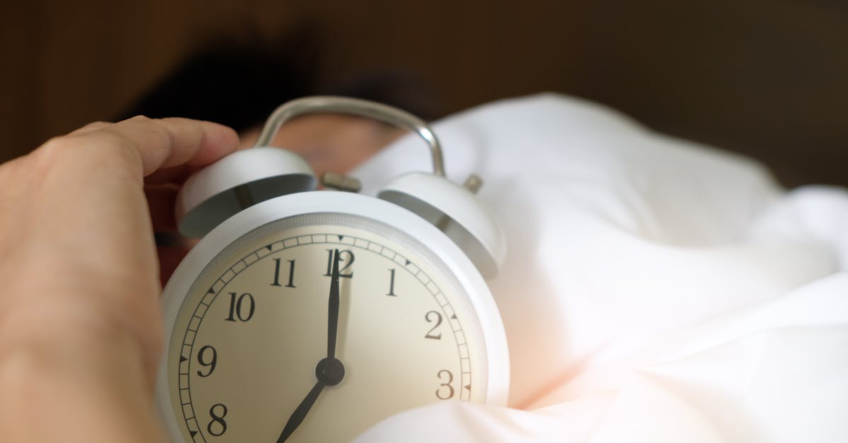 How do you deliberately wake up a monster in a den? - Photo of Person Holding Alarm Clock