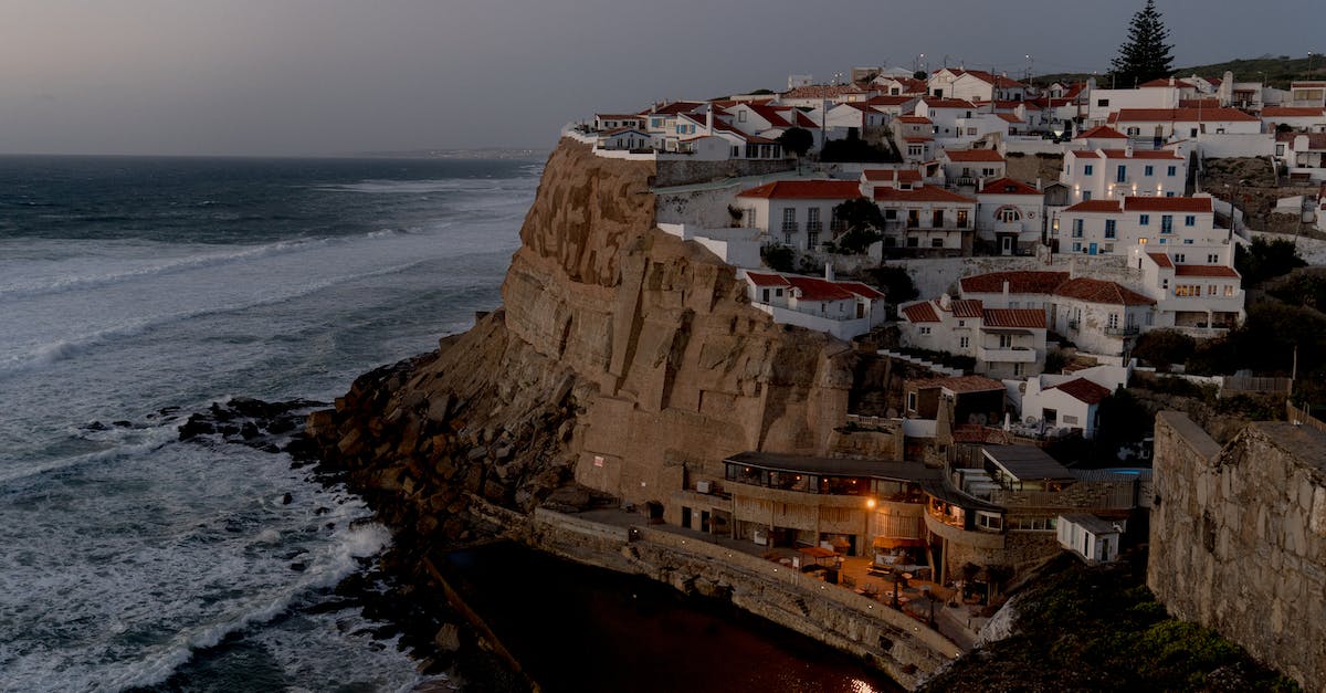 How do you find a village on survival? - Houses Perched on a Cliff Overlooking a Sandy Beach and Rocky Coastline How do you find a village on survival? - Houses Perched on a Cliff Overlooking a Sandy Beach and Rocky Coastline