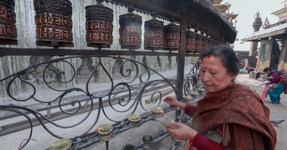 How do you get a shrine - Woman in Red and Brown Scarf Standing Near Black Metal Fence How do you get a shrine - Woman in Red and Brown Scarf Standing Near Black Metal Fence