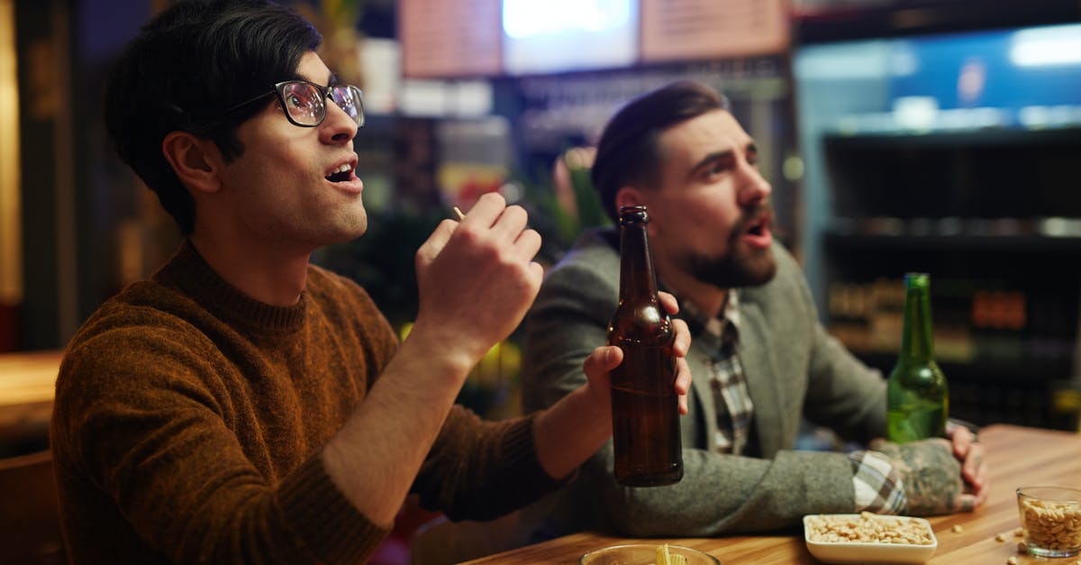 How do you get a Umbreon or Epseon during reduced buddy distance? - Man in Brown Sweater Holding Bottle