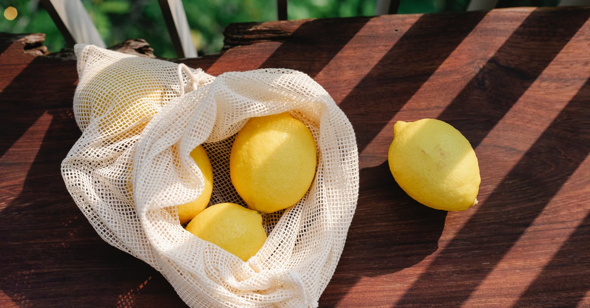 How do you harvest Phase Lemons? - Lemons in bag on wooden surface