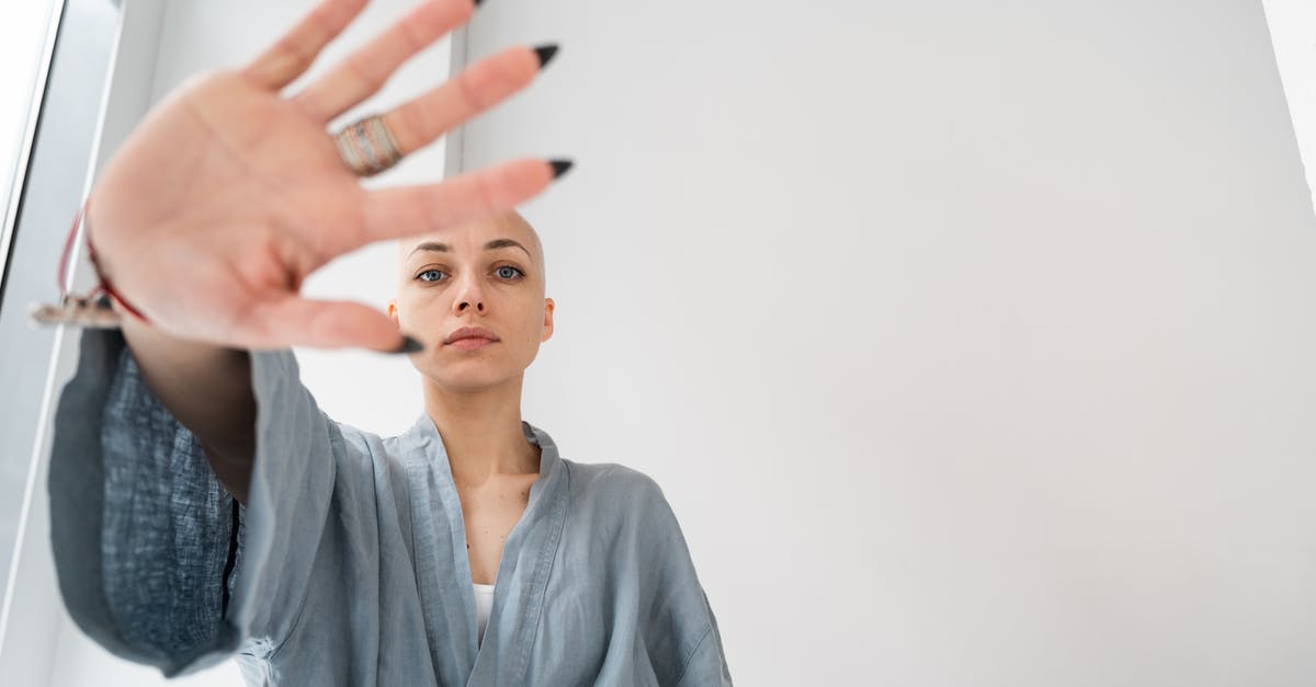 how do you hide command blocks? - Patient showing stop gesture in light clinic