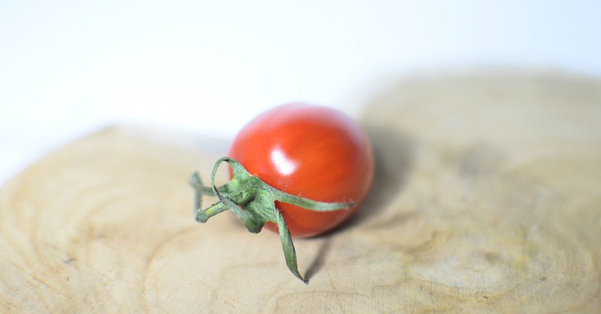 How do you hook multiple Triggerzones up to a single Respawn Pad in Rec Room? - Closeup single small ripe cherry tomato placed on shaped wooden cutting board on white table on blurred background in light kitchen