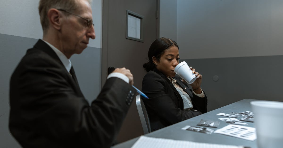 How do you interrogate someone in Another Case Solved? - Man in Black Suit Holding White Ceramic Mug