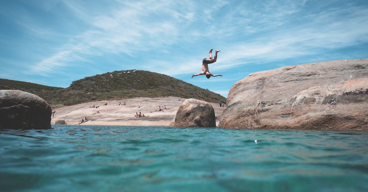 How do you jump across the water in level 1? - Anonymous man jumping into ocean during summer vacation