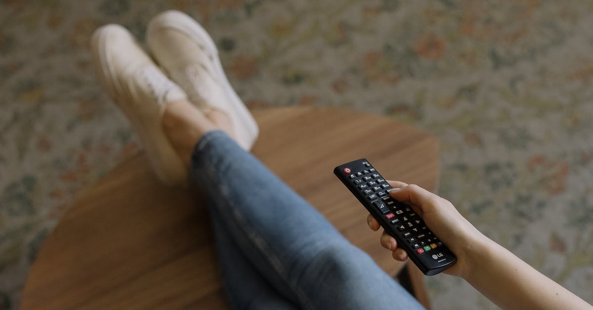 How do you keep the mobs away from your house at night? - Person in Blue Denim Jeans and White Socks Sitting on Brown Wooden Floor