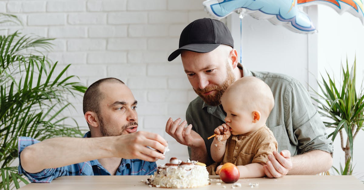 How do you kill the man eating plants? - Man in Green Long Sleeve Shirt Holding a Baby in Brown Onesie Shirt