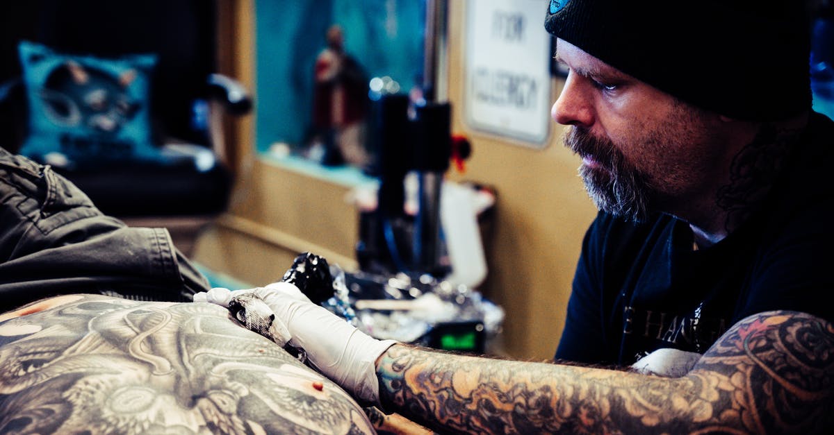 How do you know if a weapon is 1 or 2-handed without equipping it? - Man Doing Tattoo Inside Room