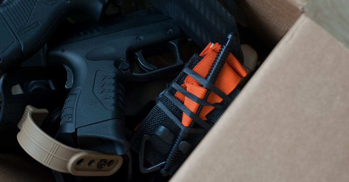 How do you know if a weapon is 1 or 2-handed without equipping it? - Black and Orange Semi Automatic Pistol