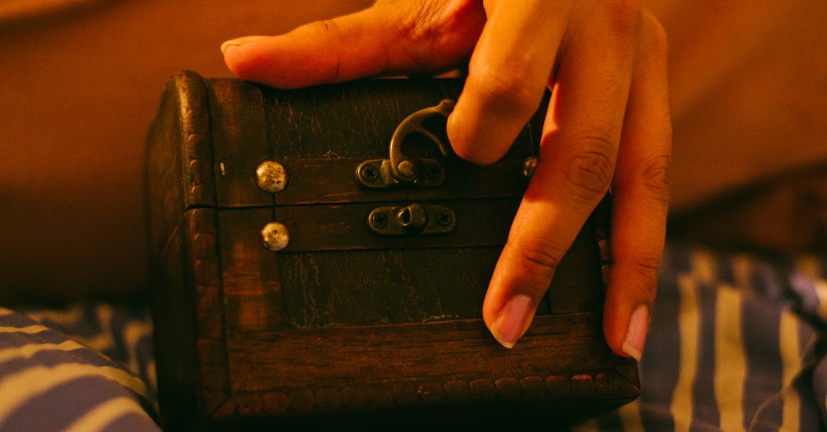 How do you lock and give chest a name? - Person Holding Brown Wooden Chest